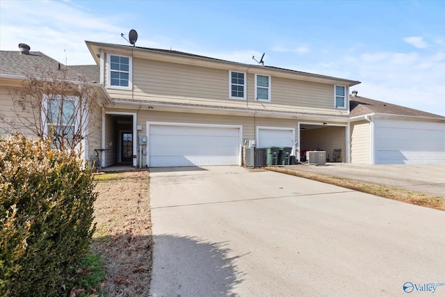 front of property with cooling unit and a garage