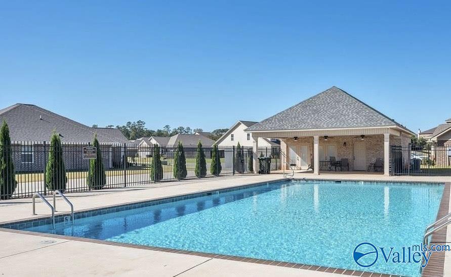 view of pool with ceiling fan and a patio