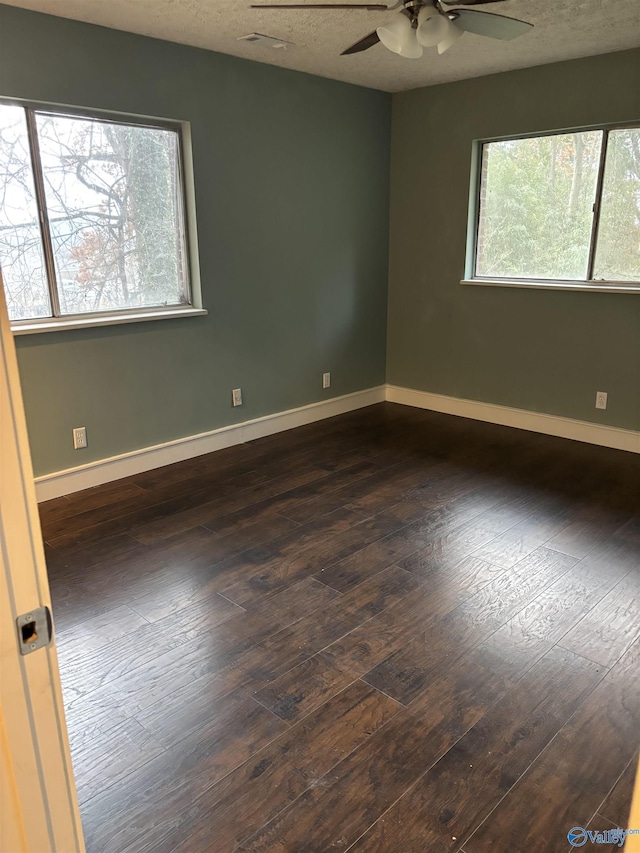 unfurnished room with dark hardwood / wood-style floors, ceiling fan, and a textured ceiling