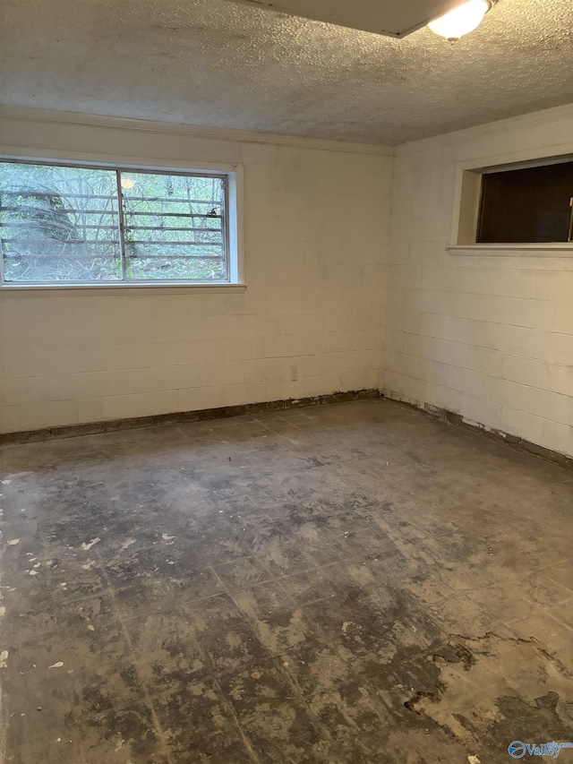 unfurnished room featuring a textured ceiling