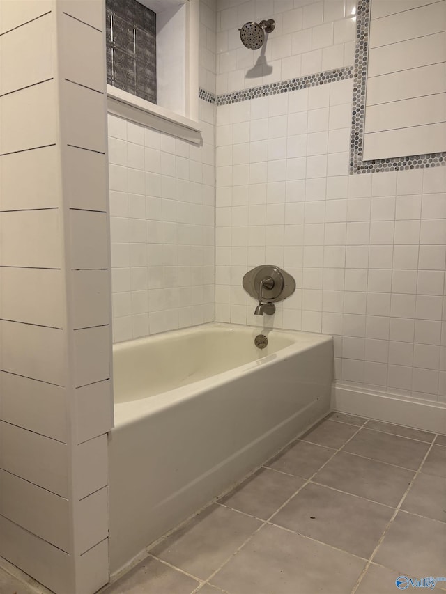 bathroom with tile patterned floors and tiled shower / bath combo