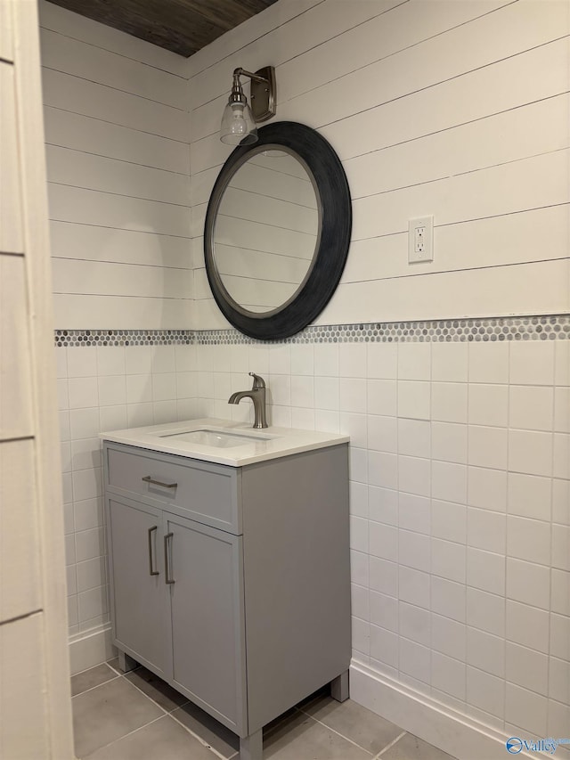 bathroom featuring vanity, tile patterned floors, and tile walls