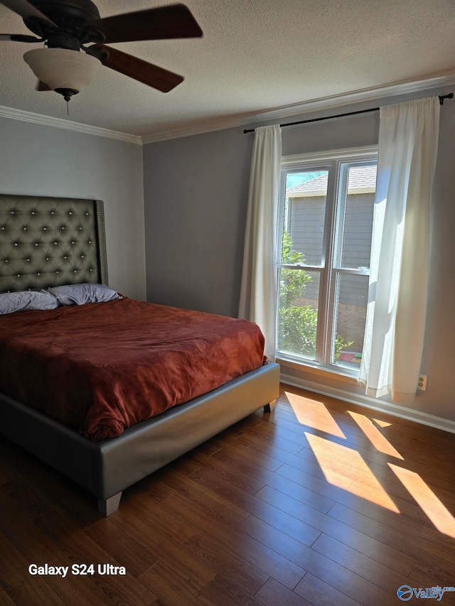 bedroom featuring a ceiling fan, crown molding, wood finished floors, and a textured ceiling