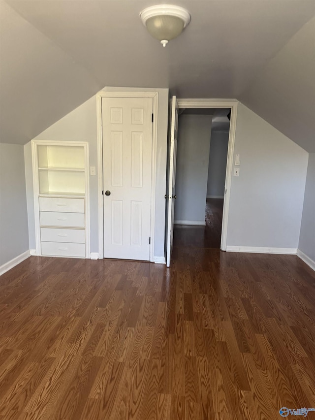 bonus room featuring lofted ceiling, baseboards, and wood finished floors