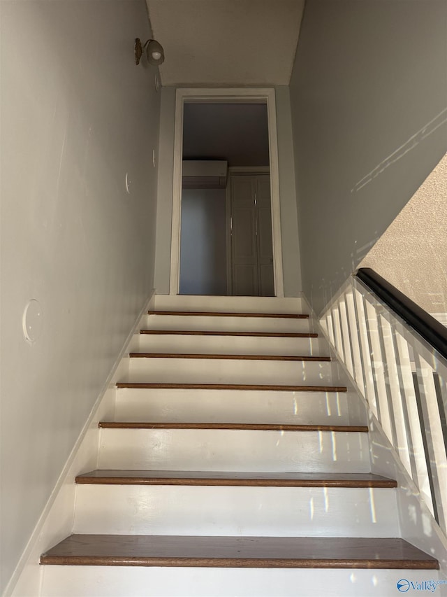 staircase featuring a wall mounted air conditioner