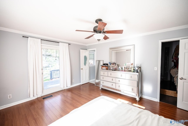 bedroom featuring visible vents, ornamental molding, wood finished floors, and access to outside