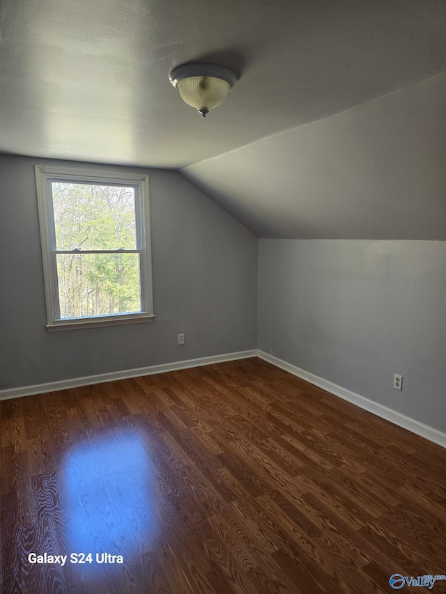 bonus room with lofted ceiling, wood finished floors, and baseboards