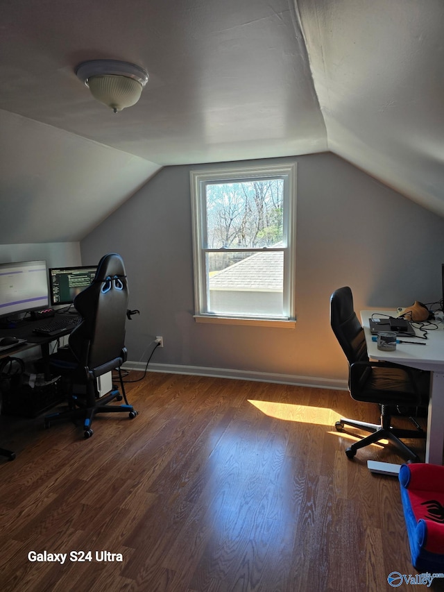 office space featuring lofted ceiling, wood finished floors, and baseboards