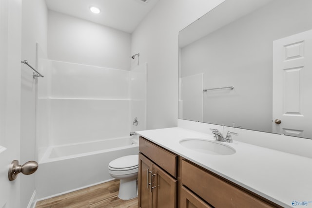 full bathroom with hardwood / wood-style flooring, vanity, toilet, and bathing tub / shower combination