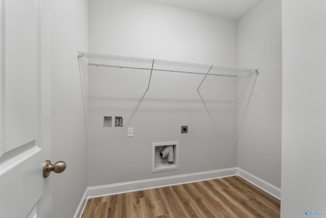 clothes washing area with wood-type flooring, hookup for an electric dryer, and hookup for a washing machine