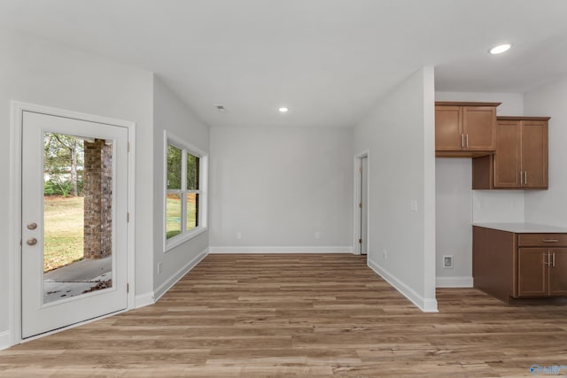 unfurnished dining area featuring light hardwood / wood-style flooring