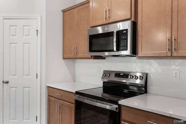 kitchen with decorative backsplash and appliances with stainless steel finishes