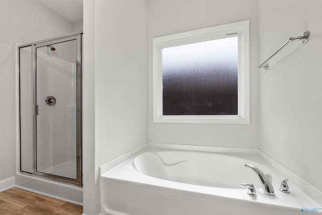 bathroom featuring hardwood / wood-style flooring and independent shower and bath