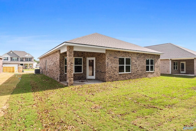 rear view of house with cooling unit, a yard, and a patio