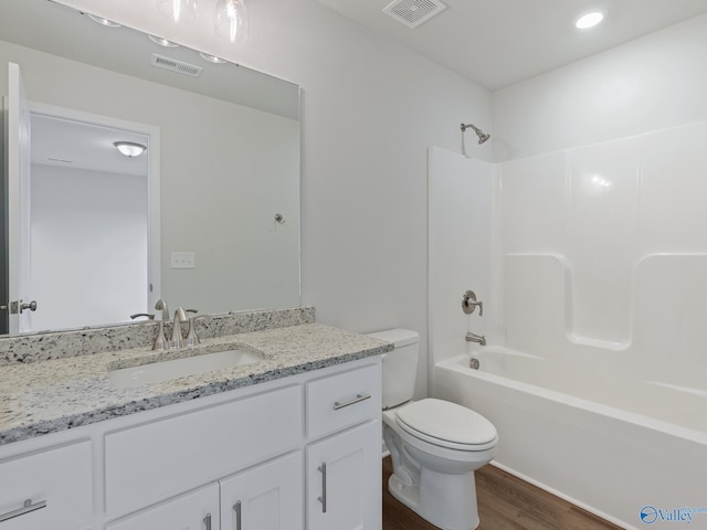 full bathroom with bathtub / shower combination, toilet, vanity, and wood-type flooring