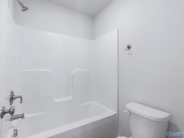 bathroom featuring toilet and  shower combination