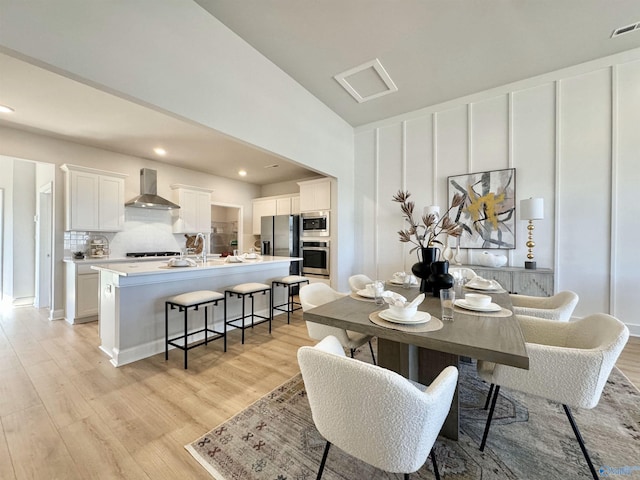 dining area with light hardwood / wood-style flooring and sink