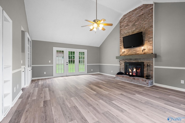 127 Patdean Dr, Huntsville, AL 35811 - unfurnished living room featuring ceiling fan, a fireplace, wood finished floors, high vaulted ceiling, and french doors