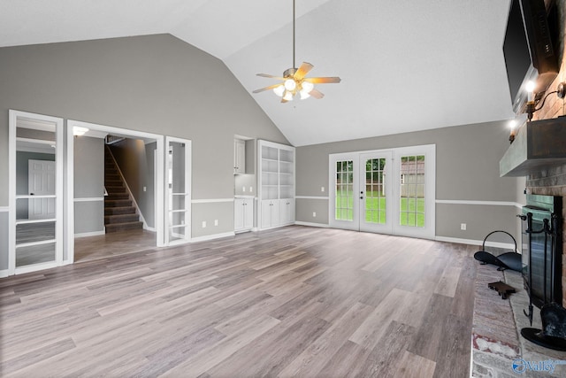 127 Patdean Dr, Huntsville, AL 35811 - unfurnished living room featuring ceiling fan, a fireplace, high vaulted ceiling, french doors, and stairway