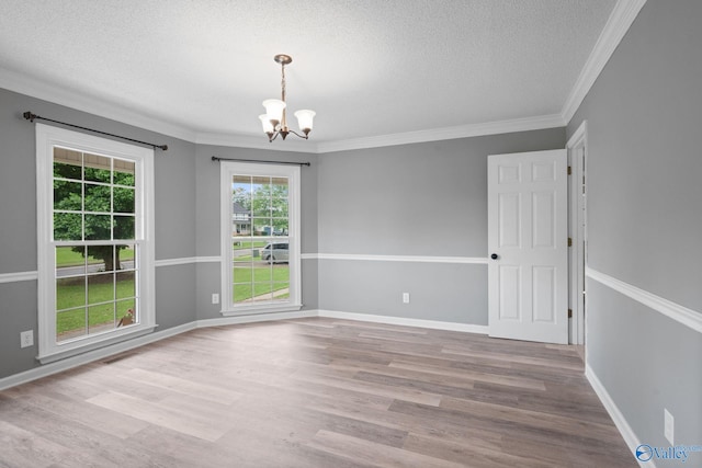 127 Patdean Dr, Huntsville, AL 35811 - unfurnished room with a chandelier, a textured ceiling, wood finished floors, and ornamental molding
