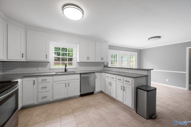 127 Patdean Dr, Huntsville, AL 35811 - kitchen featuring appliances with stainless steel finishes, decorative backsplash, a peninsula, white cabinetry, and stone countertops