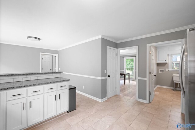 127 Patdean Dr, Huntsville, AL 35811 - kitchen with freestanding refrigerator, white cabinetry, crown molding, and stone counters