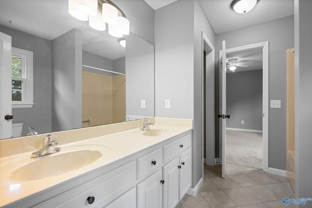 127 Patdean Dr, Huntsville, AL 35811 - full bath with tile patterned flooring, a shower, double vanity, ceiling fan, and a textured ceiling