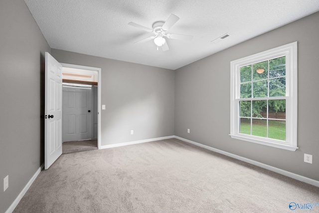 127 Patdean Dr, Huntsville, AL 35811 - unfurnished bedroom featuring carpet floors, a textured ceiling, ceiling fan, and a walk in closet