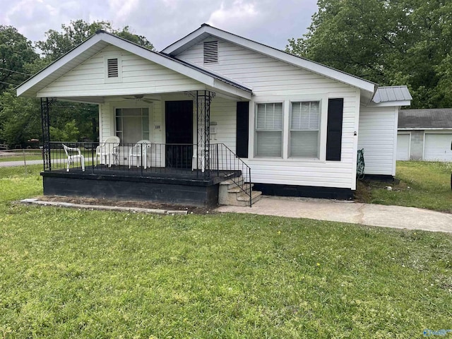 bungalow-style house with covered porch, crawl space, and a front lawn