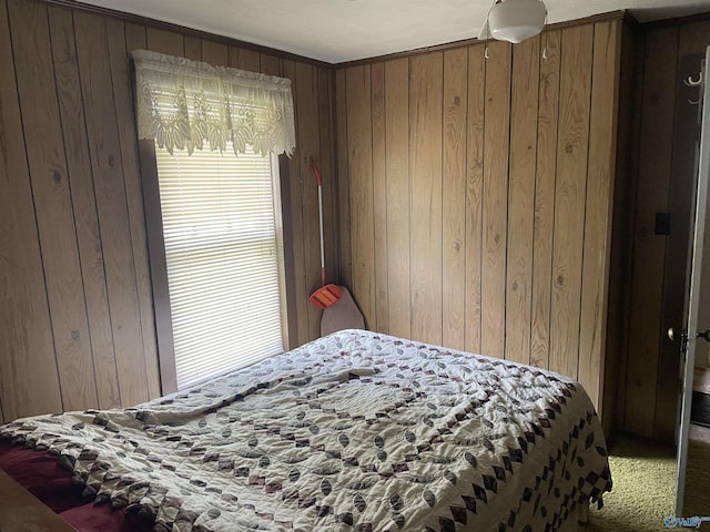 bedroom featuring wood walls and carpet floors