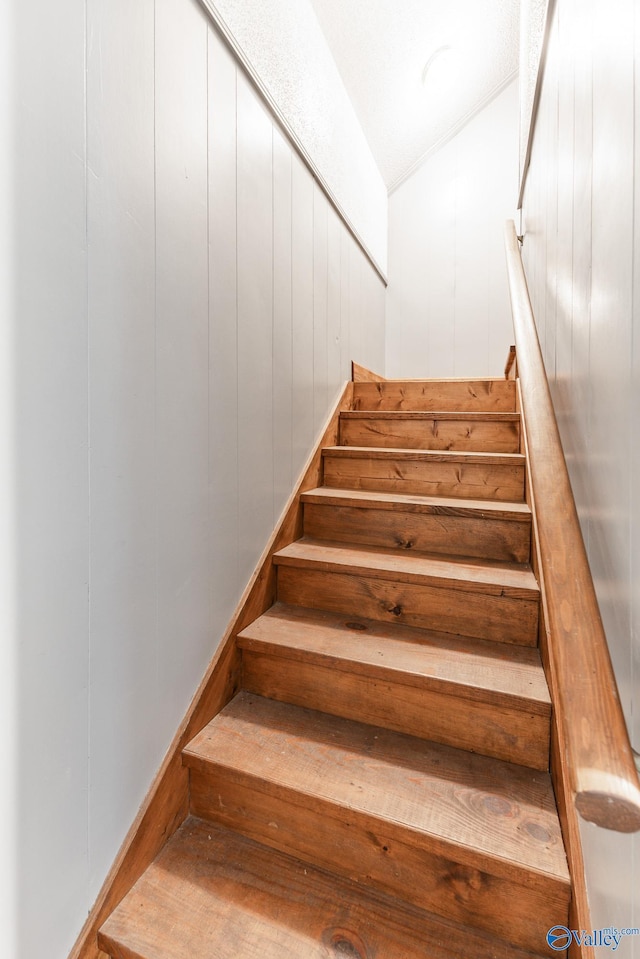 227 Key Turney Rd, Falkville, AL 35622 - stairway featuring vaulted ceiling, wood-type flooring, and wood walls