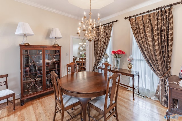 227 Key Turney Rd, Falkville, AL 35622 - dining room featuring a notable chandelier, crown molding, and light wood-type flooring