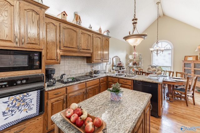 227 Key Turney Rd, Falkville, AL 35622 - kitchen featuring light stone countertops, sink, hanging light fixtures, and black appliances