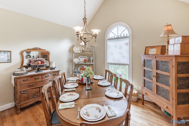 227 Key Turney Rd, Falkville, AL 35622 - dining space with vaulted ceiling, plenty of natural light, a chandelier, and light hardwood / wood-style flooring
