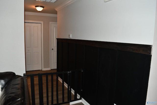 staircase with baseboards and ornamental molding