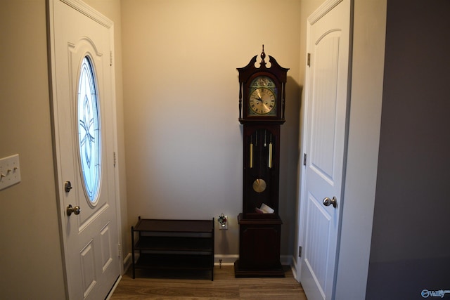 foyer entrance with wood finished floors and baseboards