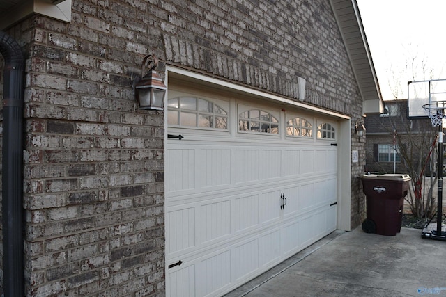 garage featuring concrete driveway