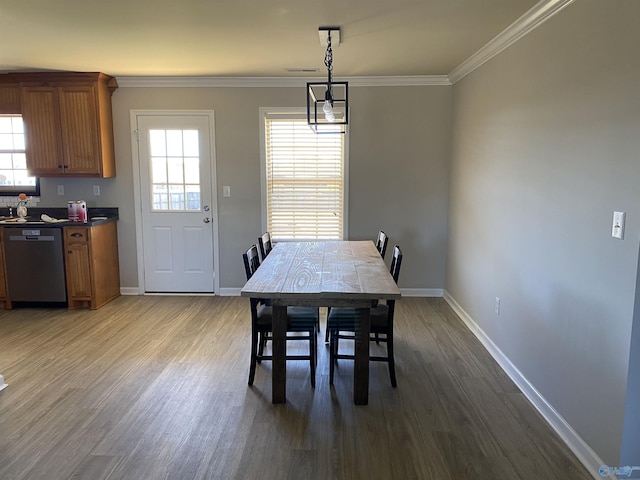 dining space featuring baseboards, a wealth of natural light, and wood finished floors