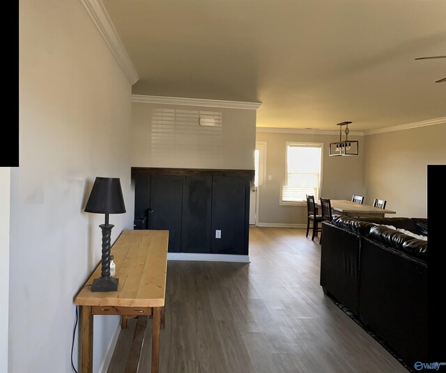 interior space featuring dark wood-type flooring, baseboards, and ornamental molding