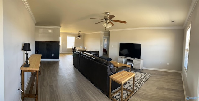 living room featuring crown molding, ceiling fan, wood finished floors, and baseboards