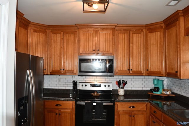 kitchen featuring tasteful backsplash, brown cabinetry, and stainless steel appliances