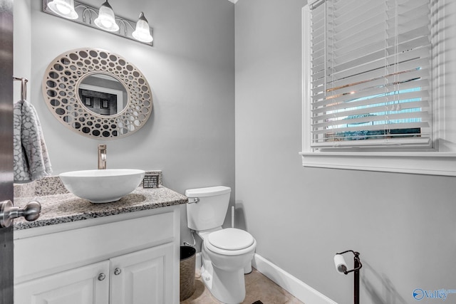 bathroom with vanity, tile patterned floors, and toilet