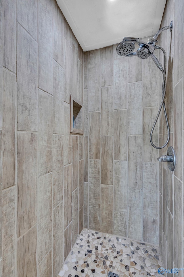 bathroom with a tile shower