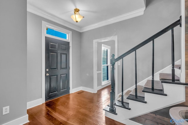 entryway featuring crown molding and hardwood / wood-style floors