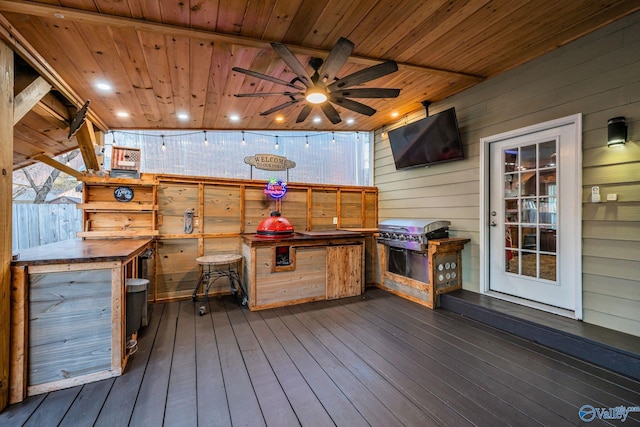 wooden terrace featuring grilling area, an outdoor bar, and ceiling fan