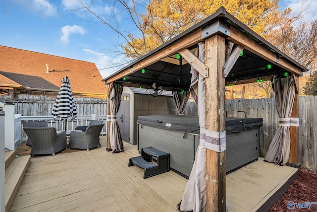 wooden terrace with a gazebo and a hot tub