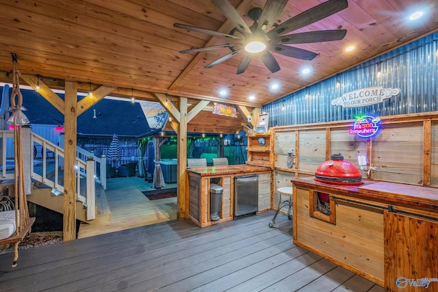 deck featuring area for grilling, an outdoor bar, and ceiling fan