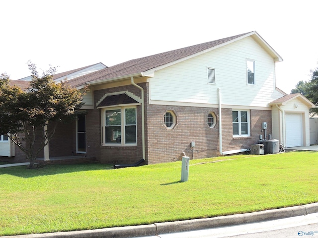 view of front facade with brick siding, cooling unit, and a yard