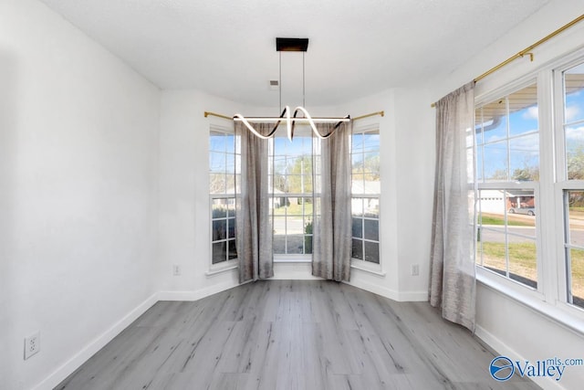 107 Harvest Glen Ln, Harvest, AL 35749 - unfurnished dining area featuring baseboards, plenty of natural light, and wood finished floors