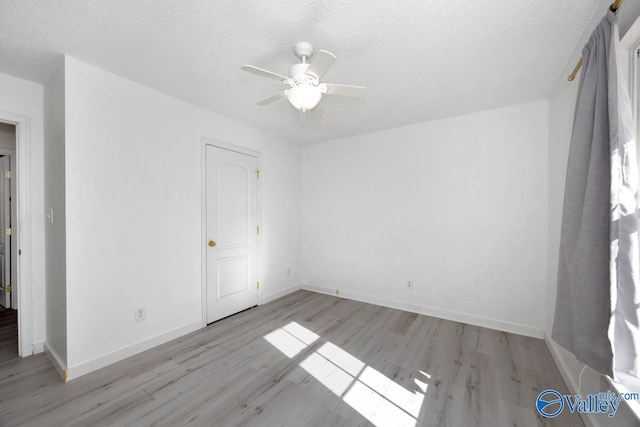 107 Harvest Glen Ln, Harvest, AL 35749 - unfurnished bedroom featuring baseboards, ceiling fan, a textured ceiling, and wood finished floors